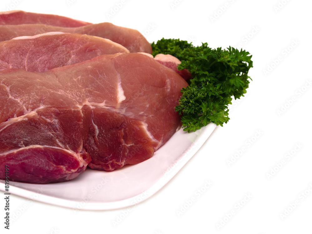 Fresh porc cuts in plate close-up view Fresh porc cuts in plate close-up view