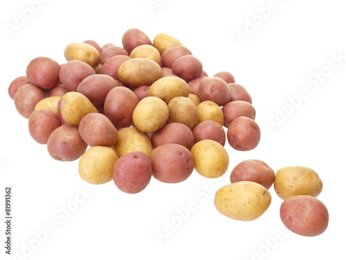 Little red and yellow patatoes mixed on white background