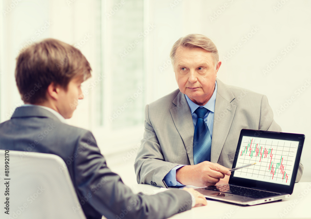 older man and young man with laptop computer older man and young man with laptop computer