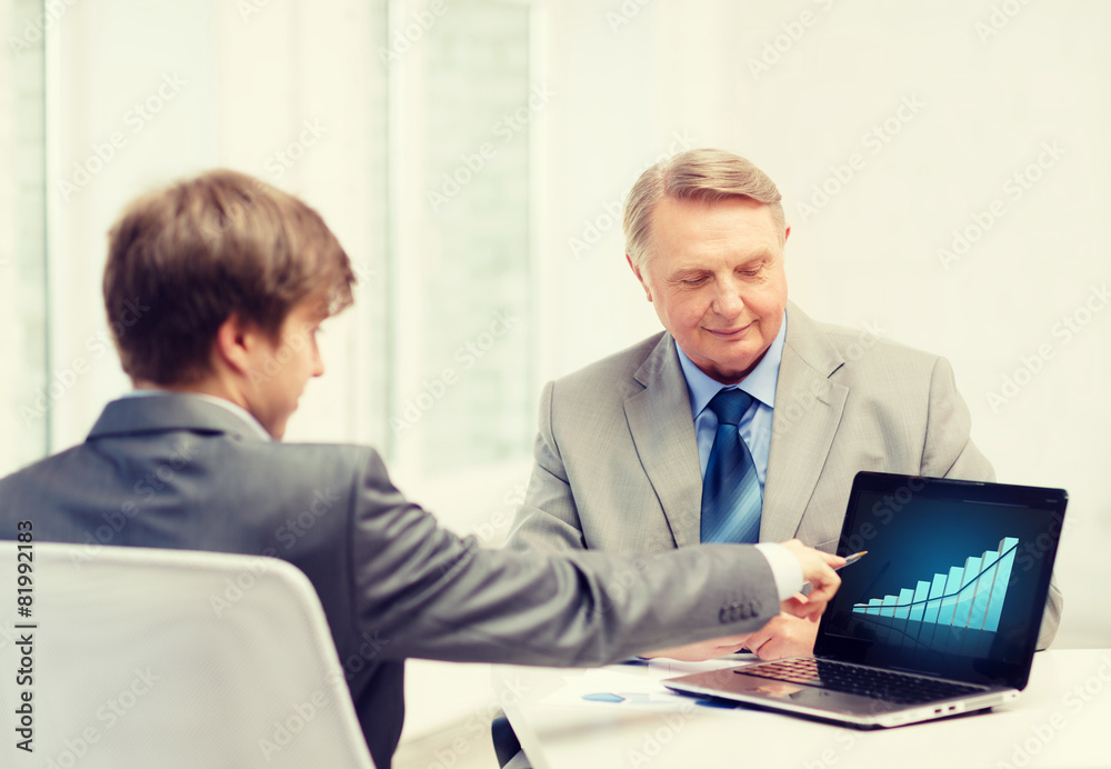 older man and young man with laptop computer older man and young man with laptop computer
