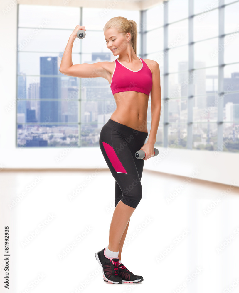young sporty woman with dumbbells