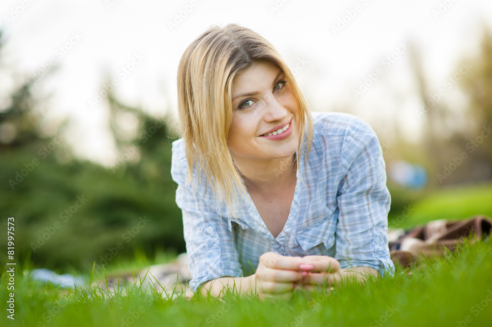portrait of a beautiful woman sitting in grass portrait of a beautiful woman sitting in grass