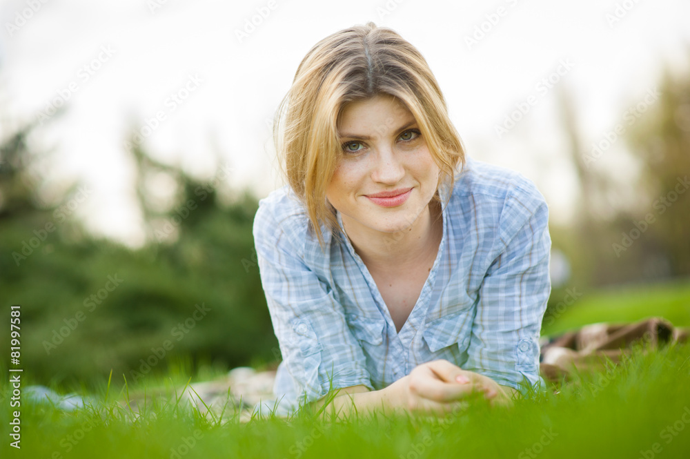 portrait of a beautiful woman sitting in grass portrait of a beautiful woman sitting in grass
