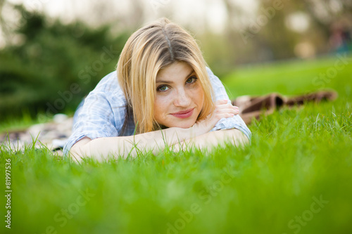 portrait of a beautiful woman sitting in grass