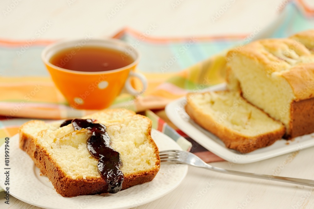 Mascarpone cake slice, cup of tea in orange teacup, blueberry ja Mascarpone cake slice, cup of tea in orange teacup, blueberry ja