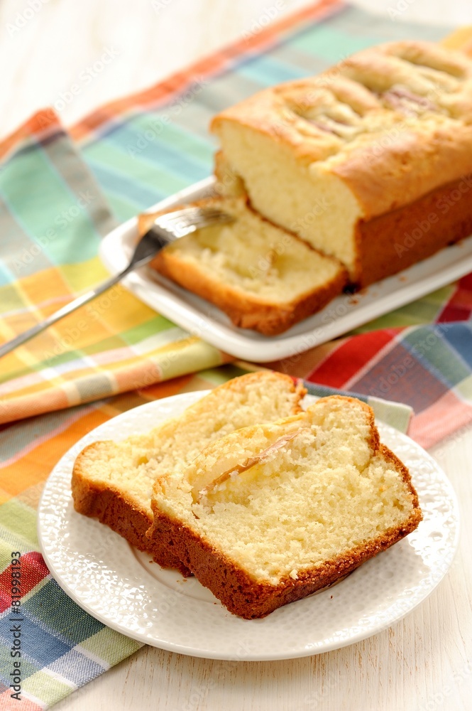 Mascarpone cake slice, long fork on white bright background