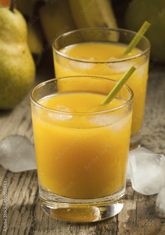 multifruit citrus juice from oranges, lemons, bananas in a glass multifruit citrus juice from oranges, lemons, bananas in a glass