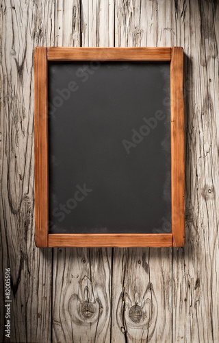 old blackboard on aged wooden wall