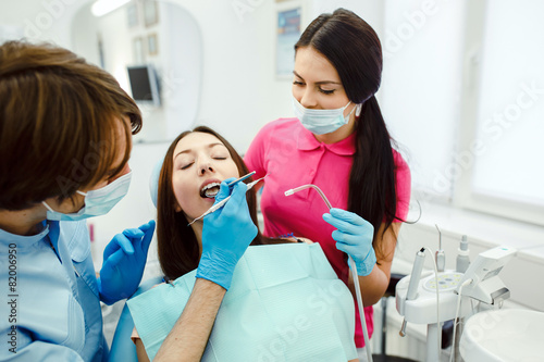 Assistant dentist and the patient in the clinic.