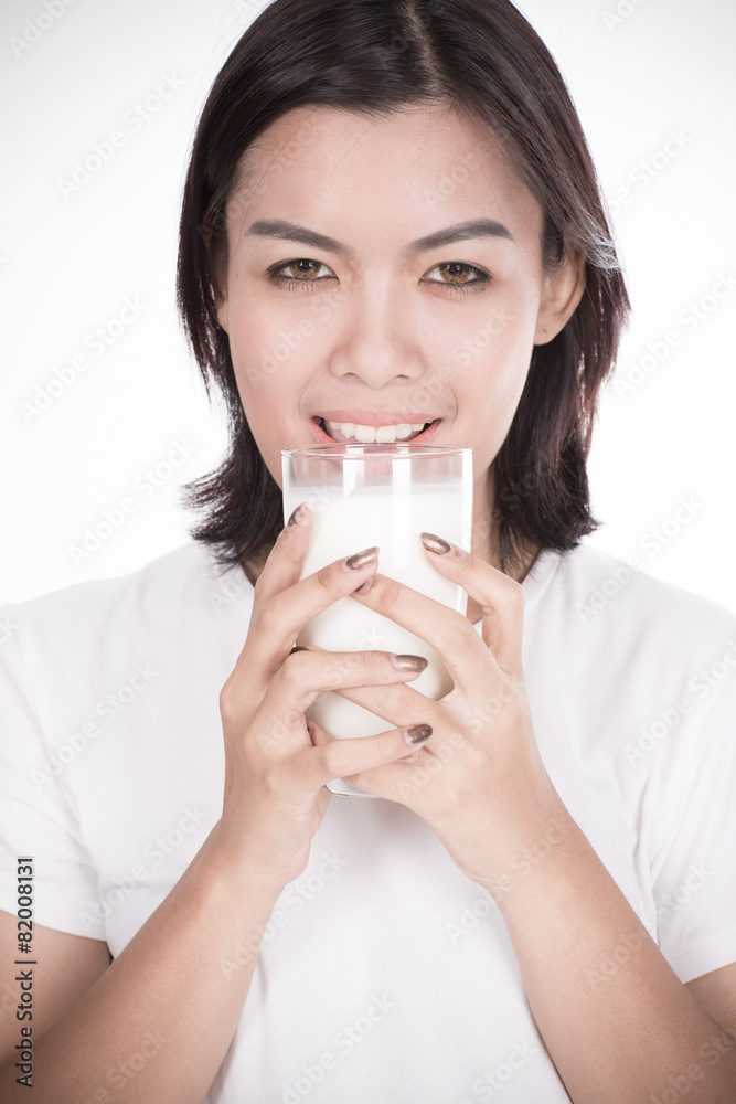 Laughing young woman with a glass of milk Laughing young woman with a glass of milk