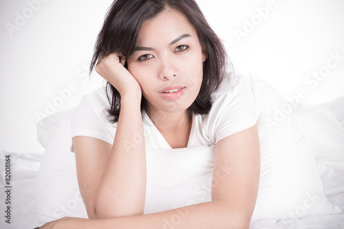 Portrait of a beautiful young woman in bed