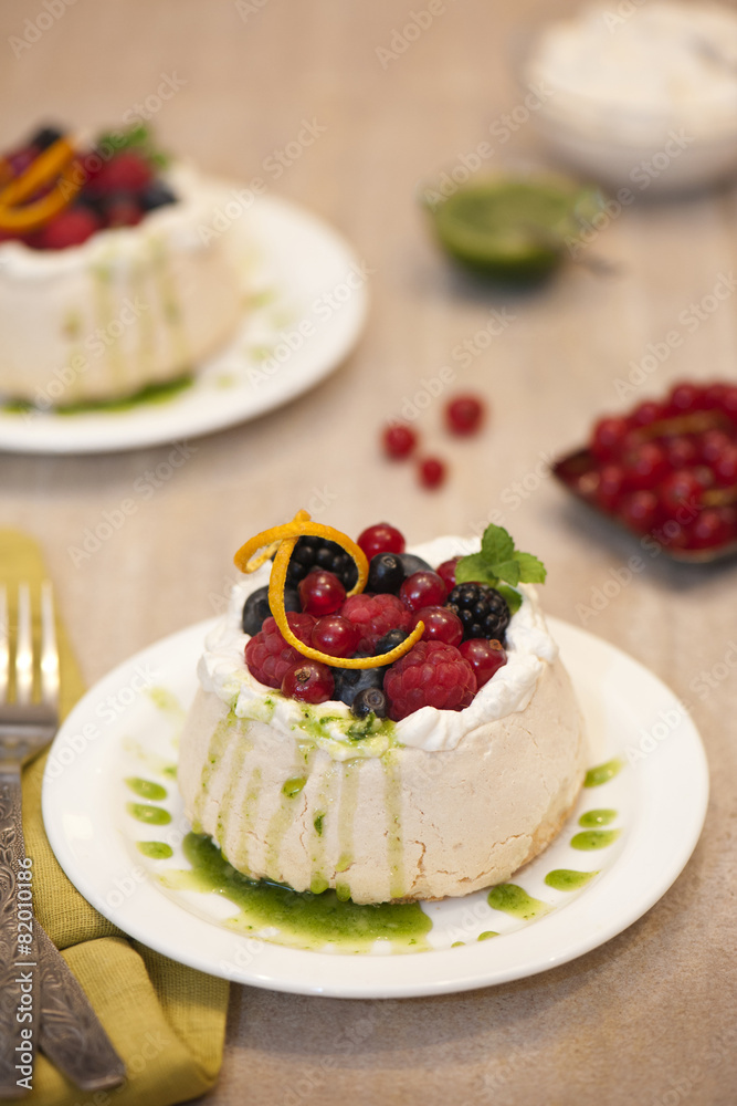 Pavlova with forest fruits and basil coulis