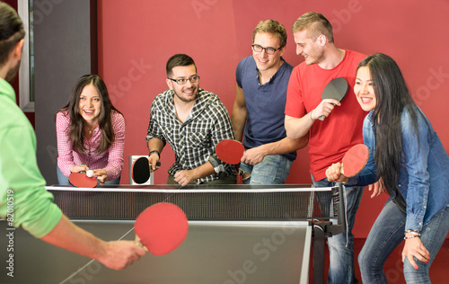 Quadro em tela Group of happy young friends playing ping pong table tennis
