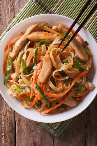 Chow mein with chicken and vegetables  top view vertical