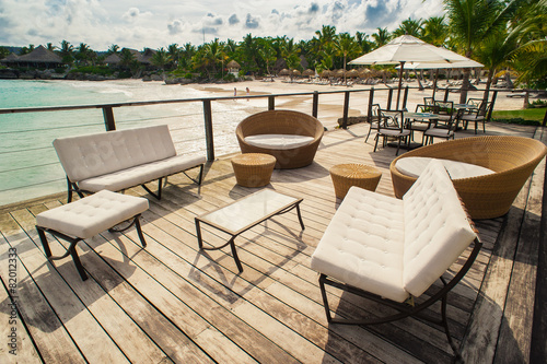 Outdoor restaurant at the seashore. Table setting in tropical