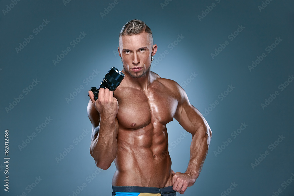 Attractive male body builder onblue background