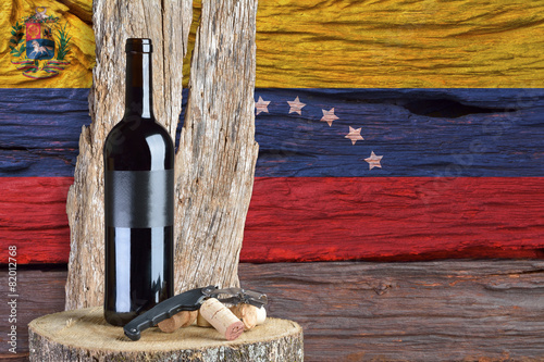 bottle of wine with Venezuela flag in the background