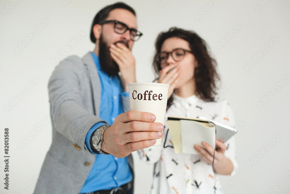 Hipster team yawning tired with coffee cup isolated on white Hipster team yawning tired with coffee cup isolated on white