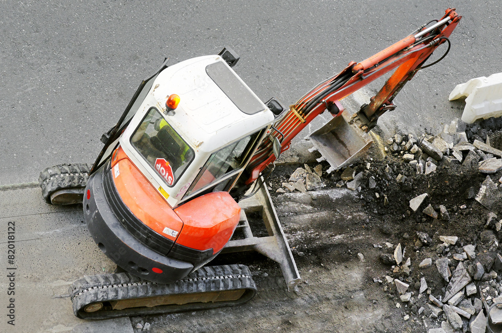 bulldozer excavator machine industry picks up debris on city str