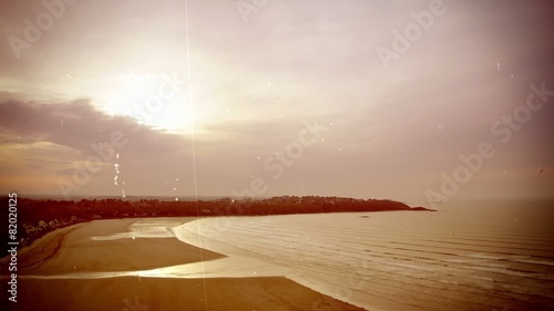 Time-lapse of a bay in evening. Old movie, sepia tones.
