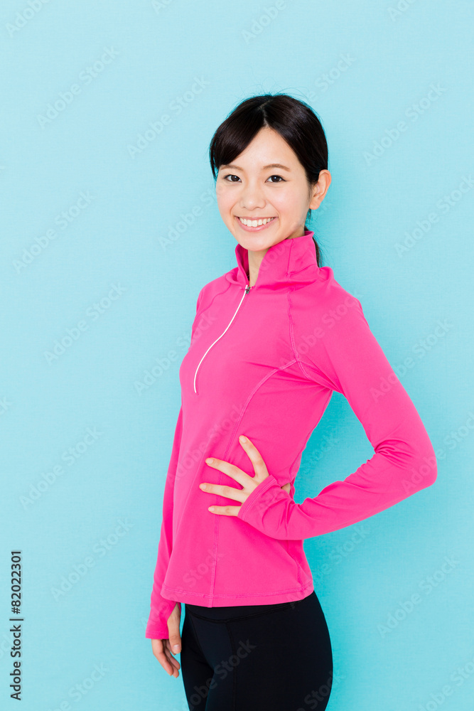 sporty asian woman on blue background sporty asian woman on blue background