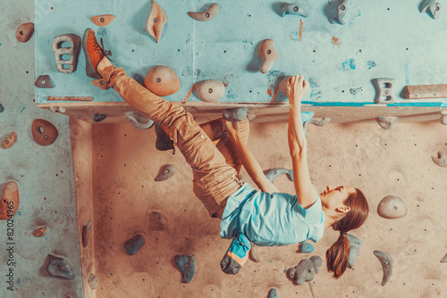 Woman training on practice climbing wall