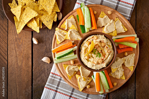 Healthy homemade hummus with vegetables, olive oil and pita chip