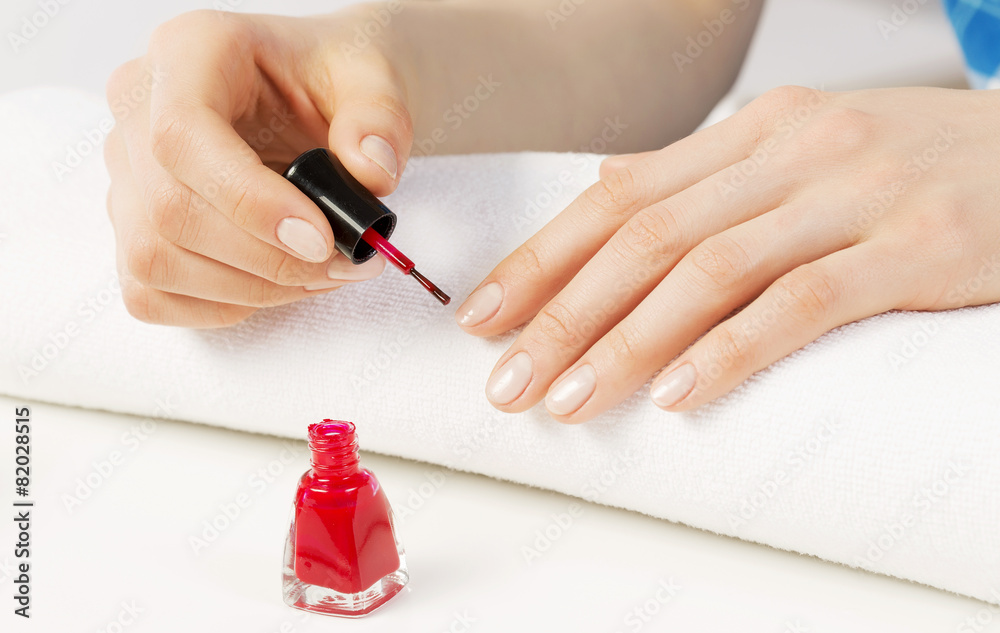 Woman applying polish Woman applying polish
