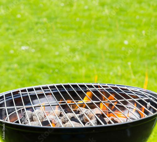 Empty grill with fire on garden