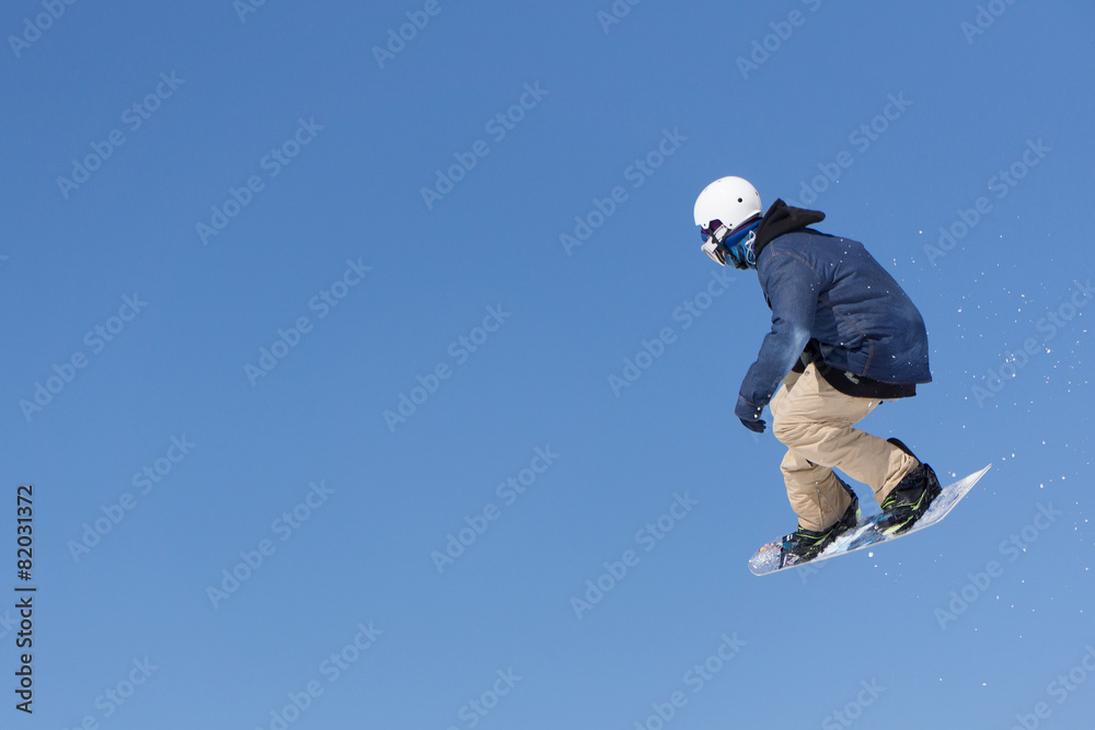 Snowboarder jumps in Snow Park Snowboarder jumps in Snow Park