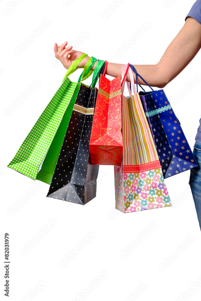 Woman hand holding multicolor shopping bags