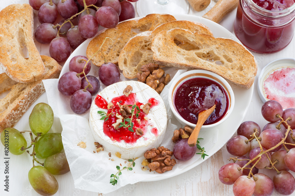 appetizers for wine - camembert with berry jam, toast and fruit