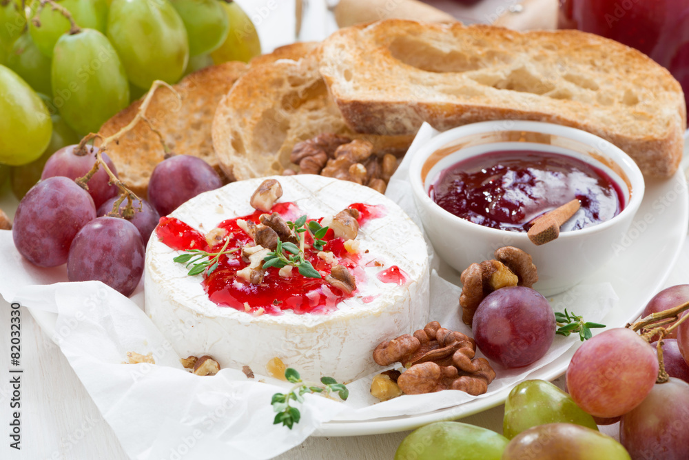 appetizers for wine - camembert with berry jam, toast and fruit appetizers for wine - camembert with berry jam, toast and fruit