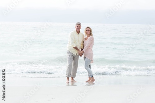 Happy couple standing by the sea