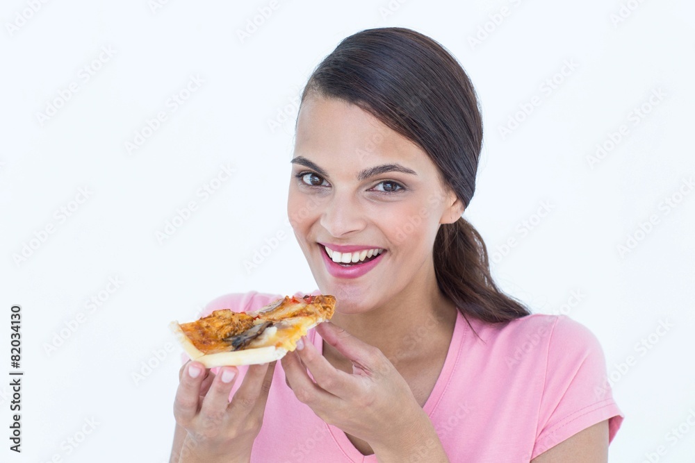 Beautiful woman eating a pizza