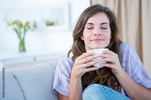 Peaceful woman holding cup of coffee