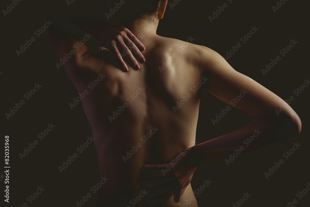 Nude woman with a back injury