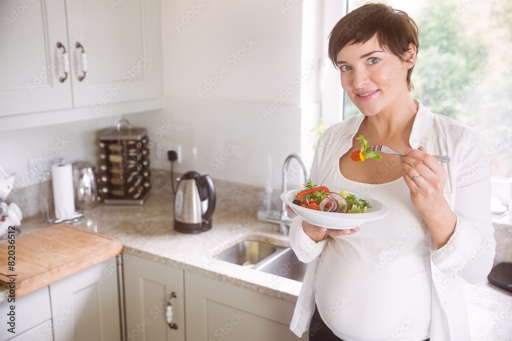 Pregnant woman having bowl of salad Pregnant woman having bowl of salad