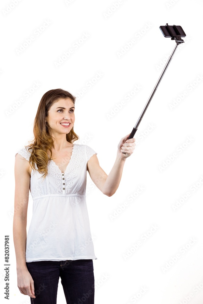 Pretty woman using a selfie stick Pretty woman using a selfie stick