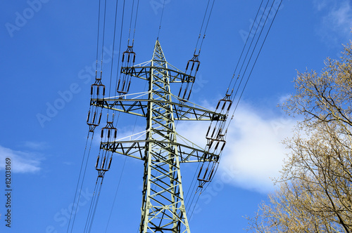 Freileitungsmast mit blauem Himmel und weißen Wolken photo