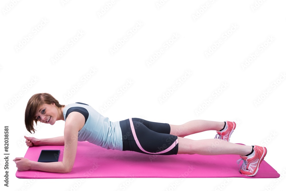 Pretty brunette doing plank on fitness mat Pretty brunette doing plank on fitness mat