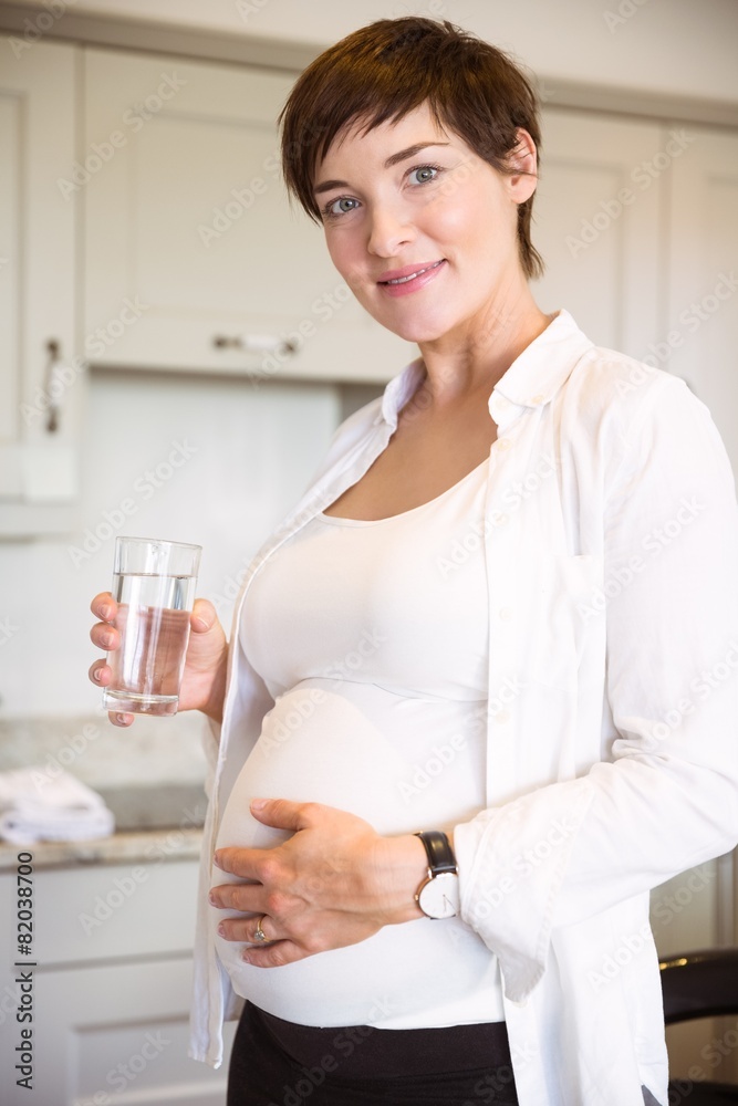 Pregnant woman having a glass of water Pregnant woman having a glass of water