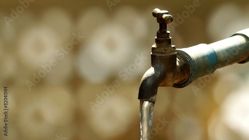 water is flowing from the old style tap