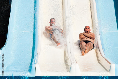 People having fun, sliding at water park