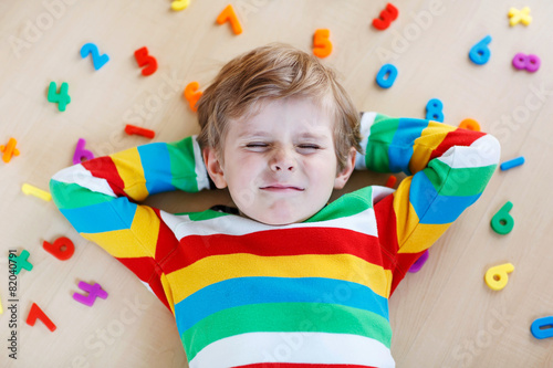 Kid boy with colorful numbers, indoor