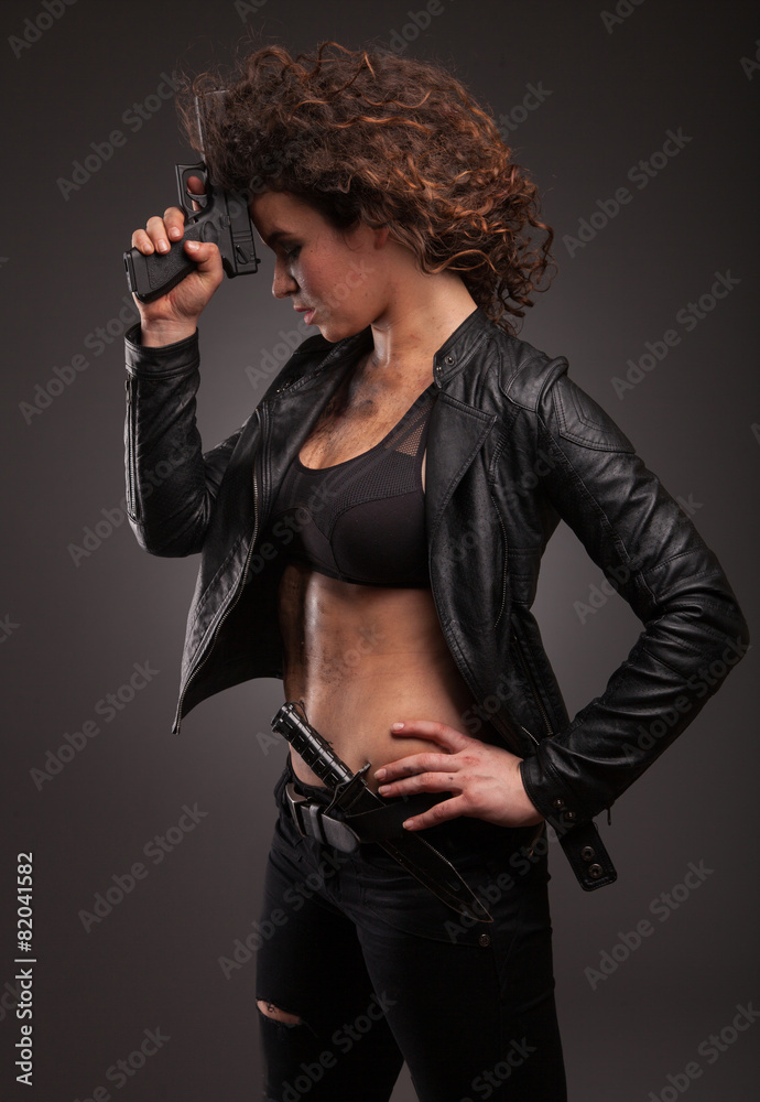 elegant and sexy lady with a gun pistol in hands. woman killer elegant and sexy lady with a gun pistol in hands. woman killer