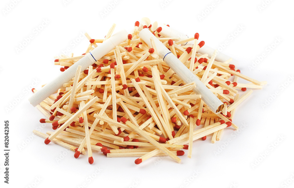 Pile of matches with cigarettes on top Pile of matches with cigarettes on top