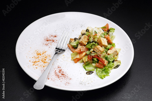 Tofu and vegetables salad. Black background photo