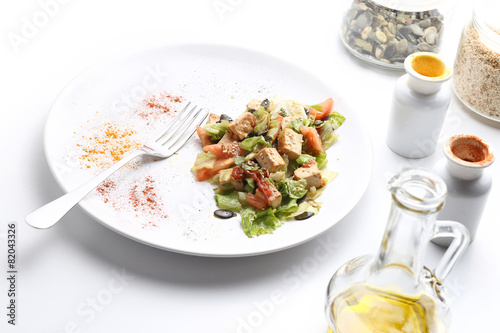 Tofu and vegetables salad. Olive oil, spices, pumpkin and sesame photo