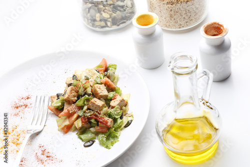 Tofu and vegetables salad. Olive oil, spices, pumpkin and sesame photo
